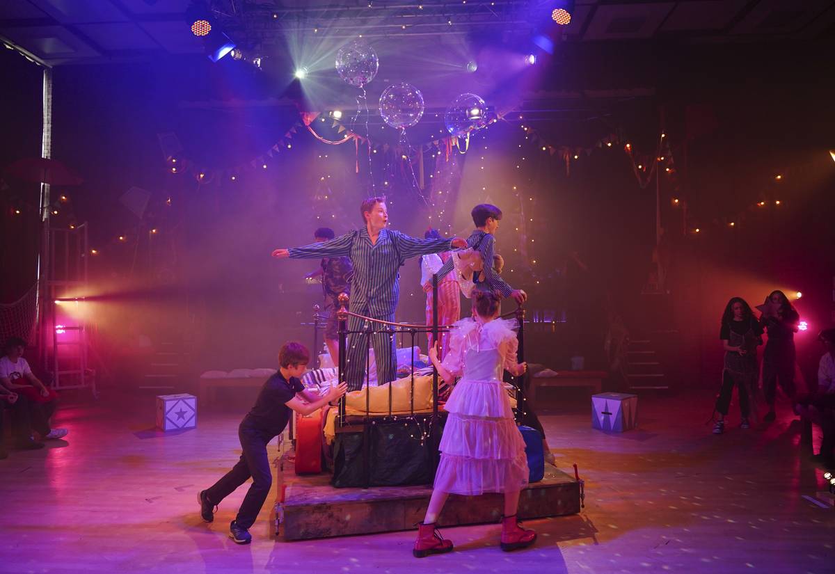 A school stage production under theatre lights